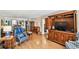 This is a living room featuring hardwood floors, living area with chairs, and views into the kitchen at 14900 Gulf Blvd # 212, Madeira Beach, FL 33708