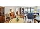 Living area features hard wood floors, dining table, sitting area with ocean view and access to balcony at 14900 Gulf Blvd # 212, Madeira Beach, FL 33708