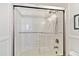 Bright bathroom shower features tile surround, sliding glass doors and updated showerhead at 14900 Gulf Blvd # 212, Madeira Beach, FL 33708