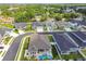 Aerial view of a private backyard with a sparkling pool, covered patio, and lush landscaping for outdoor enjoyment at 1499 Gopher Loop, Tarpon Springs, FL 34689