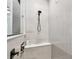 Stylish bathroom featuring a tiled shower with built-in bench and mounted shower head at 1499 Gopher Loop, Tarpon Springs, FL 34689