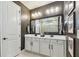 Modern bathroom with double vanity, large mirror, and sleek design, perfect for a spa-like experience at 1499 Gopher Loop, Tarpon Springs, FL 34689