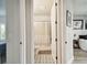 Bathroom with decorative tile floor, shower with curtain, and a door open to the bedroom at 1499 Gopher Loop, Tarpon Springs, FL 34689