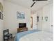 Well-lit bedroom showcases artwork, a television, a comfortable bed and an appealing ambiance at 1499 Gopher Loop, Tarpon Springs, FL 34689
