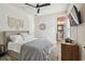 Comfortable bedroom featuring a ceiling fan and an attached bathroom for added convenience at 1499 Gopher Loop, Tarpon Springs, FL 34689