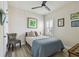 Inviting bedroom features light walls, plantation shutters, and a cozy bed with decorative pillows at 1499 Gopher Loop, Tarpon Springs, FL 34689