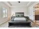 Charming bedroom featuring wood floors, ceiling fan, tray ceiling and natural light from the windows at 1499 Gopher Loop, Tarpon Springs, FL 34689