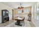 Bright dining room featuring a unique wooden table, stylish decor, and ample natural light at 1499 Gopher Loop, Tarpon Springs, FL 34689