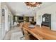 Open floor plan showcases a large wooden dining table seamlessly flowing into the living and kitchen areas at 1499 Gopher Loop, Tarpon Springs, FL 34689