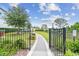 Beautiful community area with walking path and manicured garden at 1499 Gopher Loop, Tarpon Springs, FL 34689