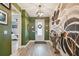Inviting entryway with a stylish door, hardwood flooring, and artistic decor at 1499 Gopher Loop, Tarpon Springs, FL 34689