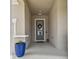 Welcoming entryway featuring a modern door, textured walls, and stylish accents at 1499 Gopher Loop, Tarpon Springs, FL 34689
