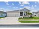 Charming single-story home featuring a manicured lawn, stone accents and a two-car garage at 1499 Gopher Loop, Tarpon Springs, FL 34689