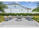 An inviting communal firepit seating area is perfect for gatherings with friends and neighbors at 1499 Gopher Loop, Tarpon Springs, FL 34689