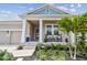 Charming front porch with rocking chairs, manicured landscaping, and welcoming curb appeal at 1499 Gopher Loop, Tarpon Springs, FL 34689