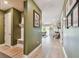Hallway with natural light showcases light-colored wood flooring, and contemporary decor at 1499 Gopher Loop, Tarpon Springs, FL 34689