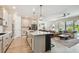 Open-concept kitchen with island, stainless steel appliances, and seamless flow to the living area at 1499 Gopher Loop, Tarpon Springs, FL 34689