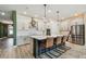 Modern kitchen with stainless steel appliances, island with seating and ample cabinet space at 1499 Gopher Loop, Tarpon Springs, FL 34689