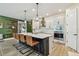 Kitchen island with bar stool seating, pendant lighting, and modern design elements at 1499 Gopher Loop, Tarpon Springs, FL 34689