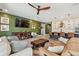 Cozy living room showcasing modern decor, an accent wall, and open access to the adjacent kitchen area at 1499 Gopher Loop, Tarpon Springs, FL 34689