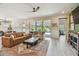 Inviting living room with comfortable seating, stylish rug, and sliding glass doors to the pool area at 1499 Gopher Loop, Tarpon Springs, FL 34689
