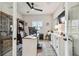 Bright home office featuring a built-in bookcase, white desk, and shuttered window at 1499 Gopher Loop, Tarpon Springs, FL 34689