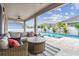 Inviting covered patio with cushioned seating, a ceiling fan, and a view of the pool at 1499 Gopher Loop, Tarpon Springs, FL 34689