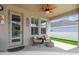 Outdoor patio area with cozy chairs, a ceiling fan, and backyard access at 1499 Gopher Loop, Tarpon Springs, FL 34689