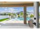 Covered patio view of the sparkling pool and backyard oasis with lush tropical landscaping at 1499 Gopher Loop, Tarpon Springs, FL 34689