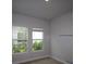 Cozy bedroom with two windows offering a serene view and ample natural light at 1631 Springwell Ln, Sarasota, FL 34240