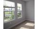 Cozy bedroom with two windows offering green views, neutral carpet and light colored walls at 1631 Springwell Ln, Sarasota, FL 34240