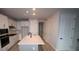 Bright kitchen featuring a large island, white cabinets, stainless steel appliances, and modern fixtures at 1631 Springwell Ln, Sarasota, FL 34240
