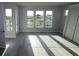 Spacious living room filled with natural light from three large windows at 1631 Springwell Ln, Sarasota, FL 34240