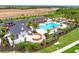Aerial view of community pool and playground with ample parking and landscaping at 17116 Moonflower Dr, Venice, FL 34293