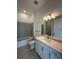 Well-lit bathroom with a combination tub and shower and a modern vanity at 17116 Moonflower Dr, Venice, FL 34293