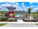 Stunning clubhouse features coastal architecture, a covered patio, lush landscaping, and views of the community pool at 17116 Moonflower Dr, Venice, FL 34293