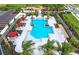 Aerial view of the community pool features inviting cabanas, shade trees, and a spacious sun deck at 17116 Moonflower Dr, Venice, FL 34293