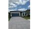 Charming single-story home with a blue garage door and paver driveway at 17116 Moonflower Dr, Venice, FL 34293