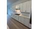 Modern kitchen with white cabinets, subway tile backsplash, and stainless steel appliances at 17116 Moonflower Dr, Venice, FL 34293