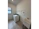 Functional laundry room with a utility sink and included washer and dryer at 17116 Moonflower Dr, Venice, FL 34293