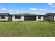 Beautiful backyard view of the house featuring a covered lanai and green lawn at 1797 Pepper Grass Dr, North Port, FL 34289