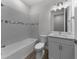 Clean bathroom featuring a tiled shower-tub and vanity with storage at 1797 Pepper Grass Dr, North Port, FL 34289