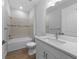 Bathroom featuring a white vanity, tub and tiled shower at 1797 Pepper Grass Dr, North Port, FL 34289