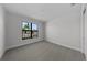 Bedroom featuring carpeted floor, white walls, and large window at 1797 Pepper Grass Dr, North Port, FL 34289