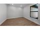 Bedroom featuring wood-look flooring, white trim and a window at 1797 Pepper Grass Dr, North Port, FL 34289