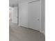 Hallway showing the closet with a sliding door and entry to the bathroom at 1797 Pepper Grass Dr, North Port, FL 34289