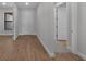 Hallway featuring wood-look tile flooring, neutral paint, and white doors at 1797 Pepper Grass Dr, North Port, FL 34289