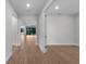 Hallway displaying wood-look tile flooring and views into adjoining rooms at 1797 Pepper Grass Dr, North Port, FL 34289
