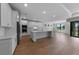 Stylish open-concept kitchen boasts a large island, stainless steel appliances, and modern white cabinets at 1797 Pepper Grass Dr, North Port, FL 34289