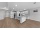 Open-concept kitchen featuring a large island, stainless steel appliances, and modern cabinetry at 1797 Pepper Grass Dr, North Port, FL 34289